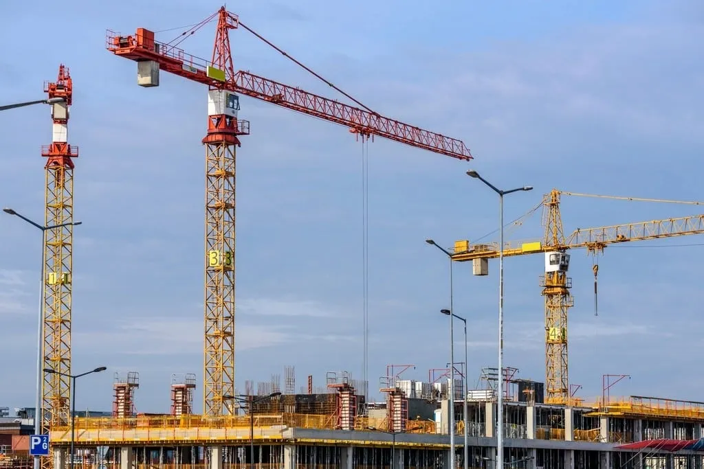 Tower cranes above a building under construction
