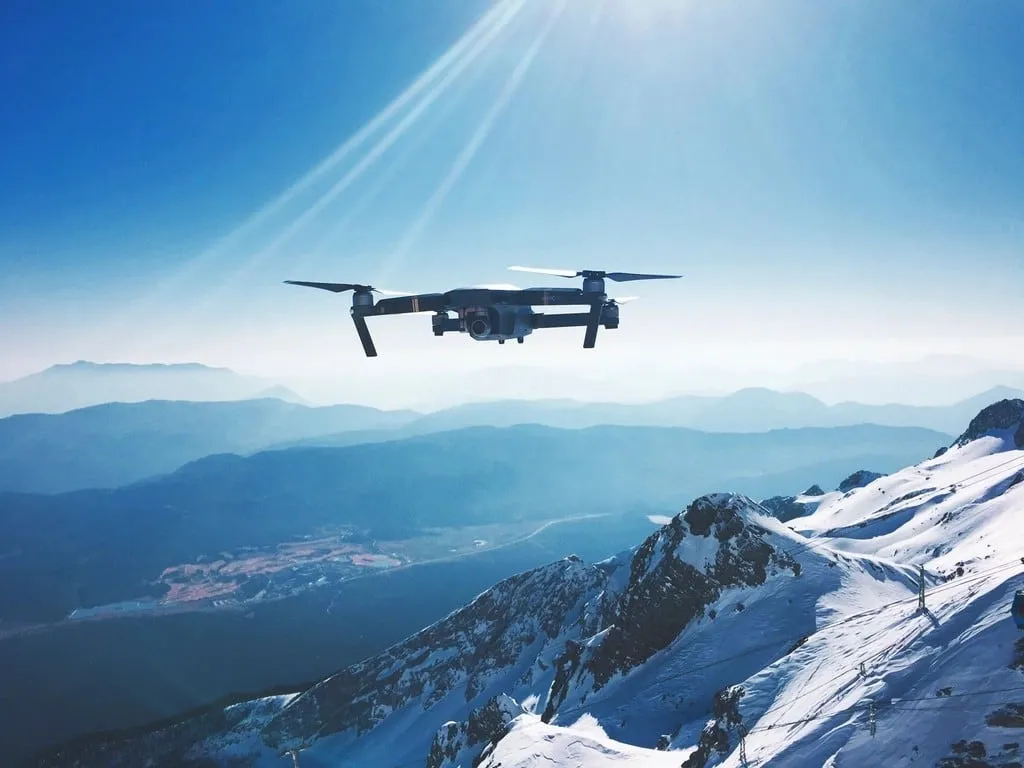 Survey drone flying above a mountain valley